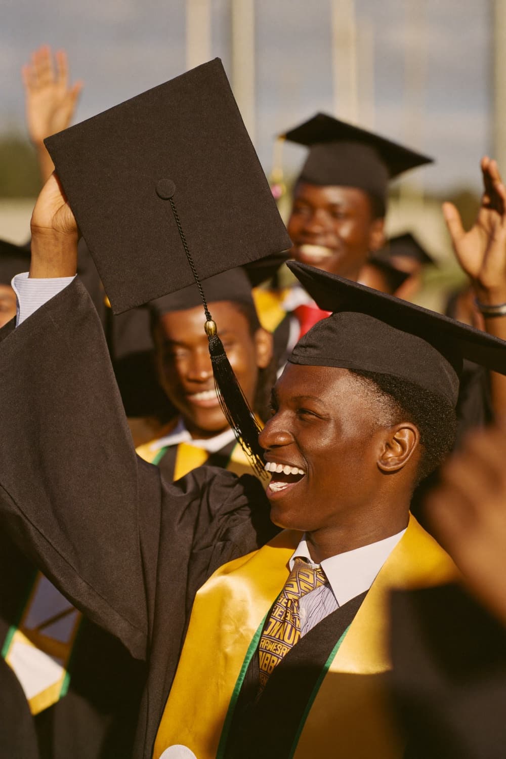 Two graduates in caps and gowns celebrating graduation day